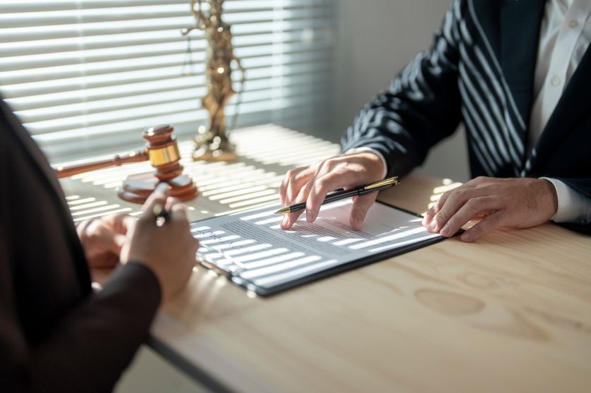 Lawyer explaining contract details to client in office Analyse du pacte Dutreil et ses implications fiscales